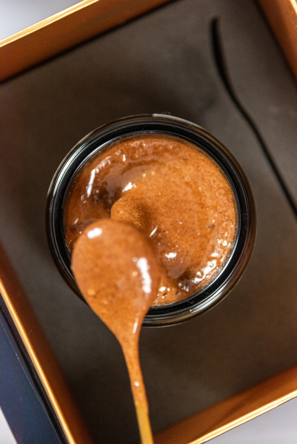 A spoonful of Immunis blend lifted from an open jar